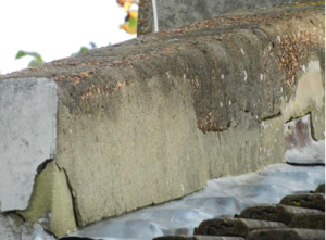 Image of cracked and loose render on a parapet wall