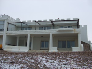 Rear View of 1 Western Esplanade, Hove, abutting a beach sprinkled with snow.