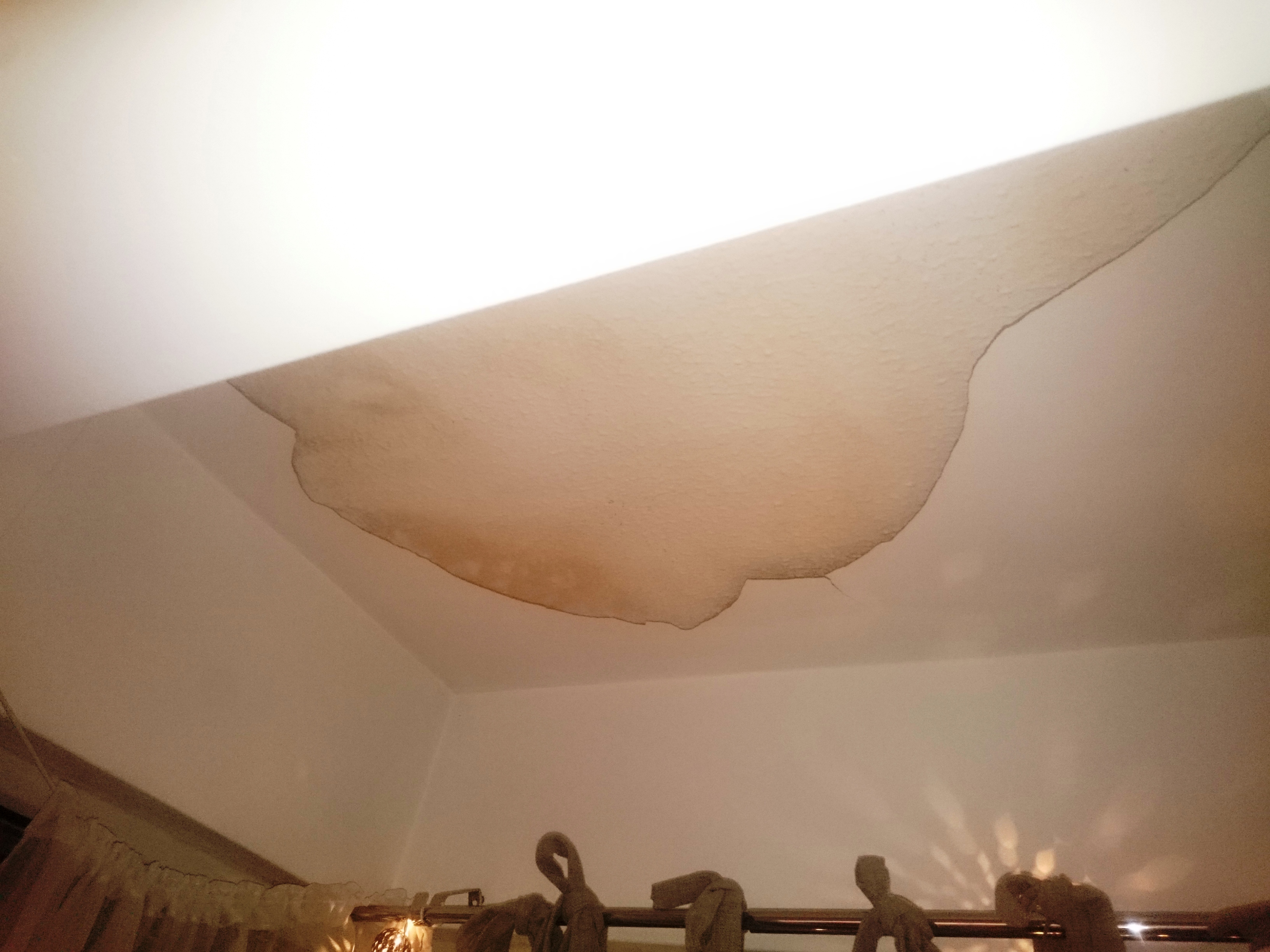 Large damp patch on ceiling of a flat - caused by cold bridging