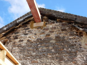 Beam being inserted into a party wall